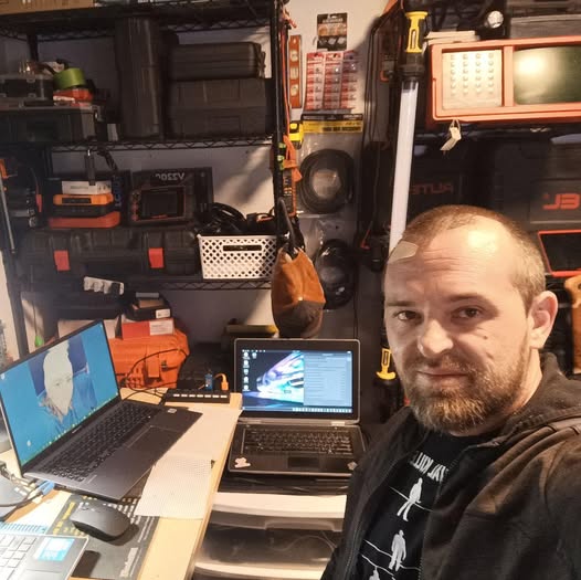 Technician at the diagnostic workbench with two laptops